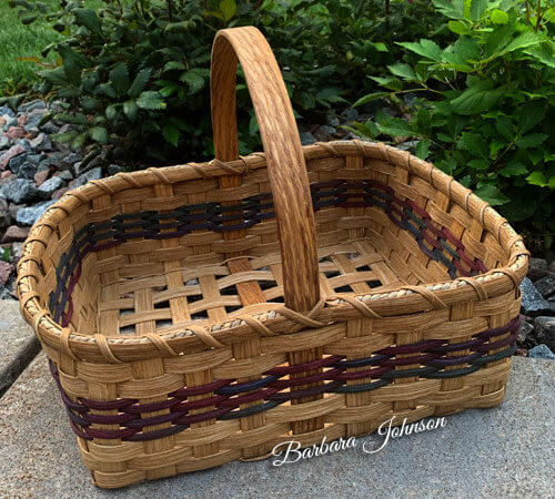 empty gardener basket with 4 rows of colors weaved in the middle of the basket