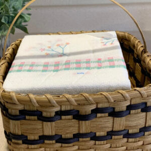 Handmade napkin basket with a stack of napkins