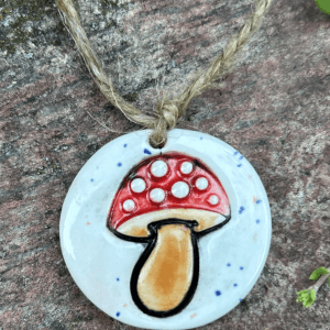 This is a handmade Mushroom Embellishment made of stoneware.